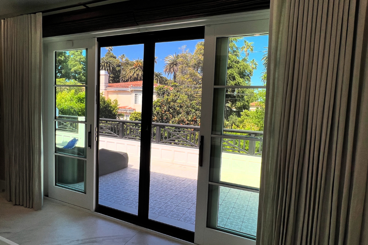 A beautiful home with sliding doors and security door screens installed that are designed to maintain a clear view while providing a strong security barrier in Southern California.